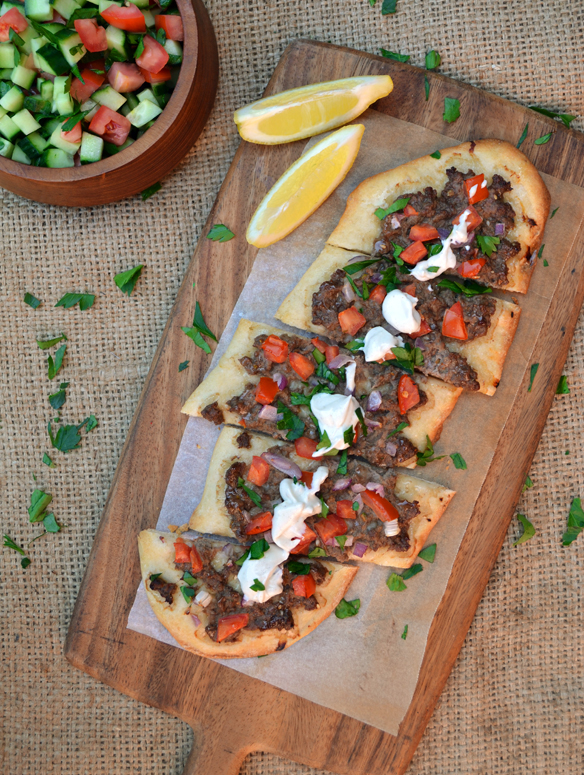 Spiced lamb pizza with tahini sauce. One Equals Two.